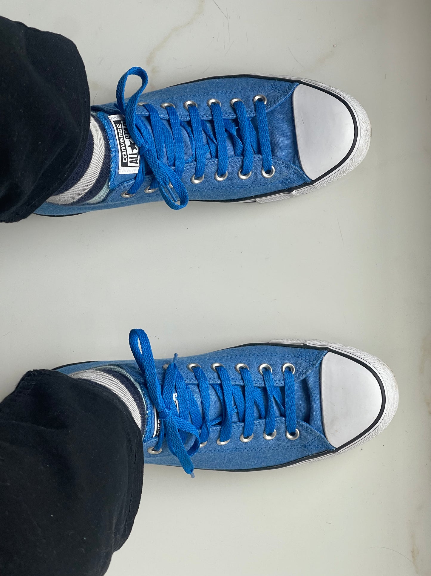 blue low-top Converse shoes